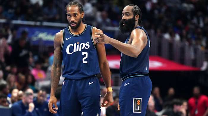 Clippers forward Kawhi Leonard and guard James Harden talk on the court during their game against the Pelicans.